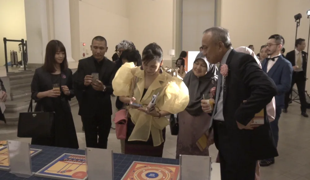 Guests at the exhibition, printed panels laid out as scan targets.