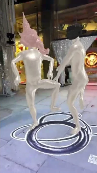 The dancers return to the plaza as an AR layer, shareable from a phone